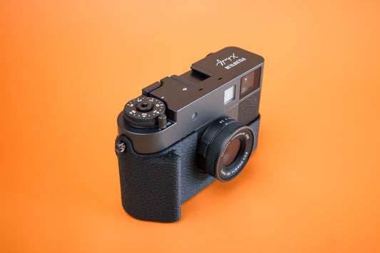 Akara Labs Slim Skin Case fitted to a Fujifilm X half in black leatherette-textured TPU