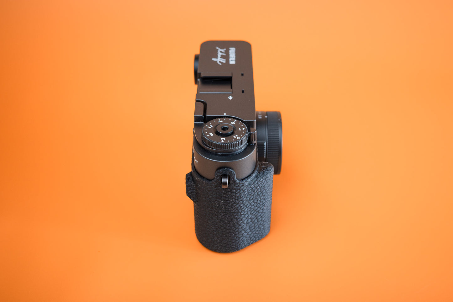 Fujifilm X half in Slim Skin Case with grip, side profile view showing TPU wrap and cutouts