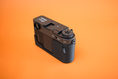 Fujifilm X half in Slim Skin Case, right side view showing exposure dial, case cut-out for the screens and thumb grip