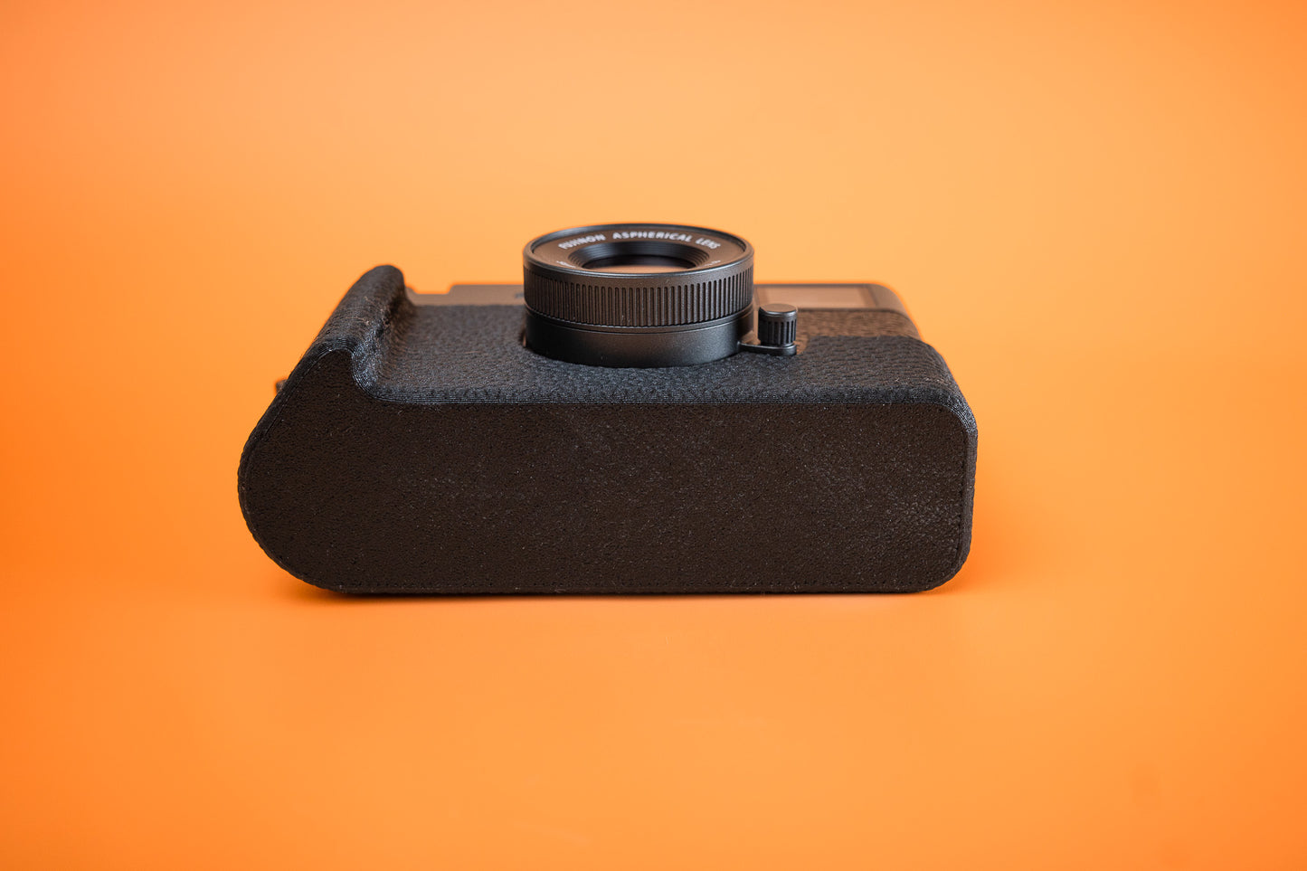 Fujifilm X half in Slim Skin Case with grip, base view showing flat bottom