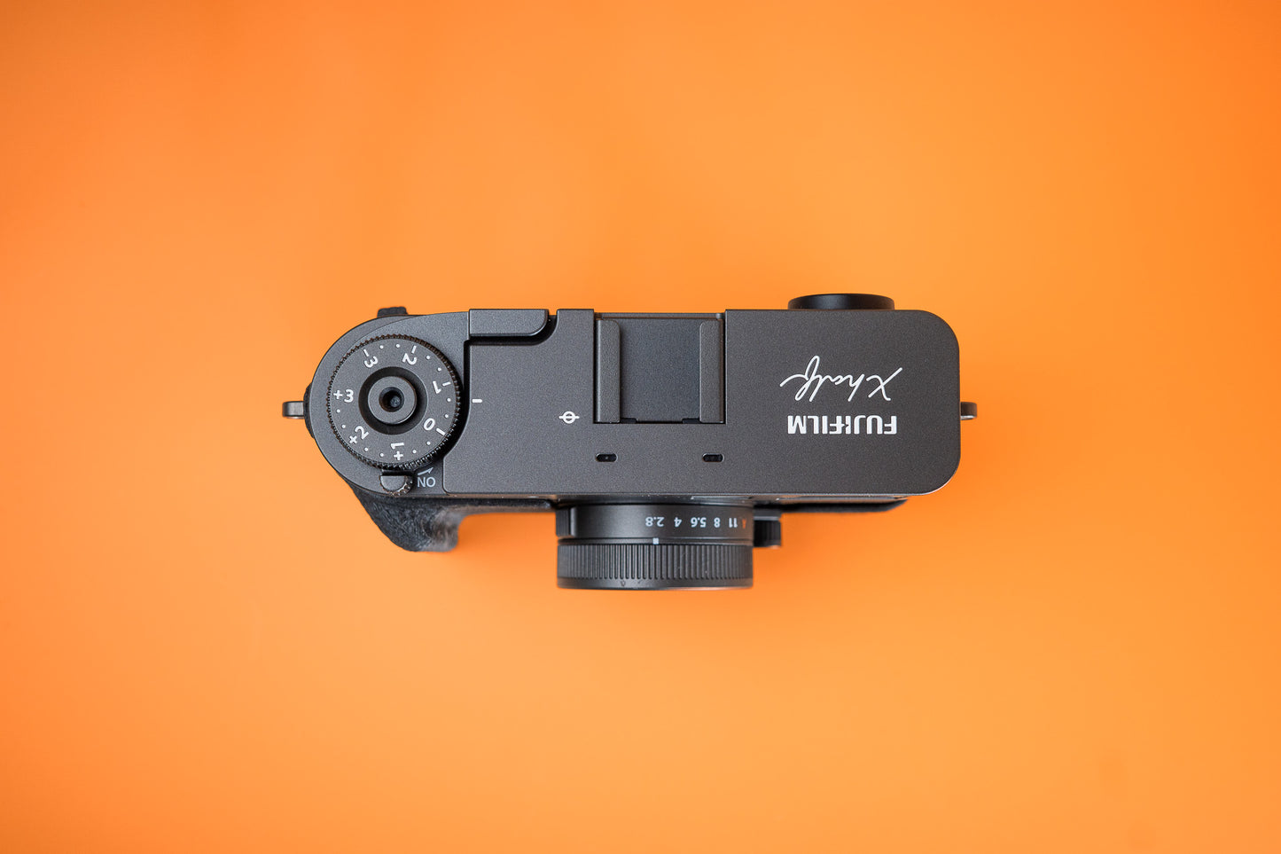 Fujifilm X half in Slim Skin Case with grip, top view showing grip, thumbie and top of camera