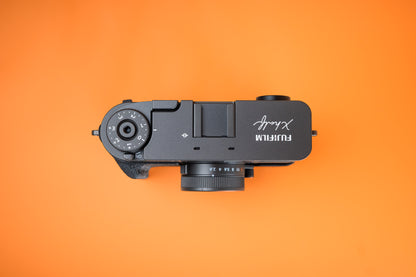 Fujifilm X half in Slim Skin Case with grip, top view showing grip, thumbie and top of camera