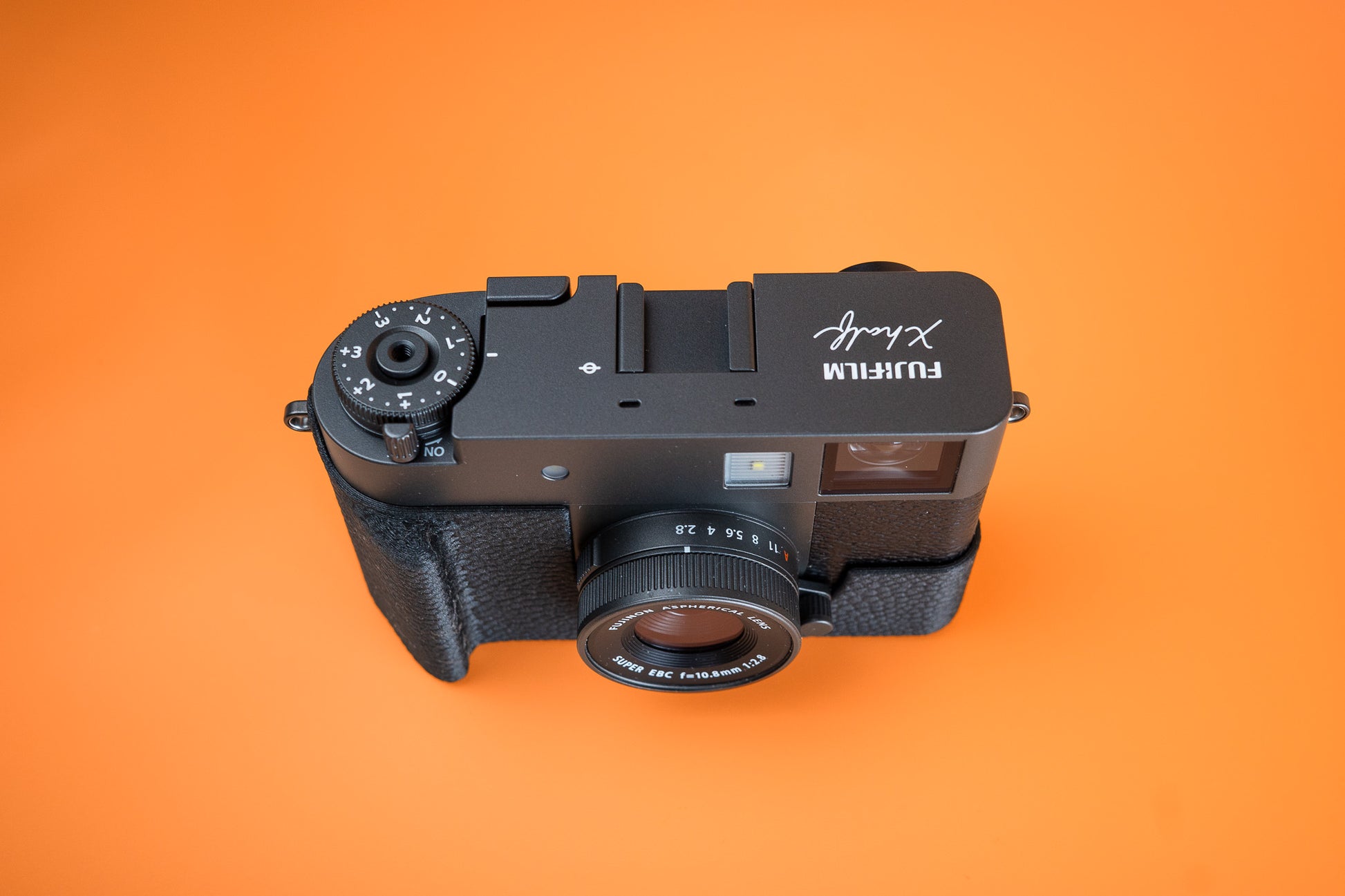 Fujifilm X half in Slim Skin Case with grip, angled view showing grip and top of case and camera