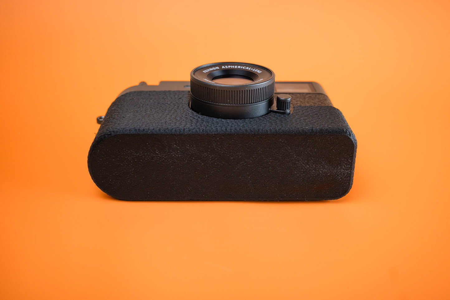 Fujifilm X half in Slim Skin Case with no grip, angled view showing base of the case