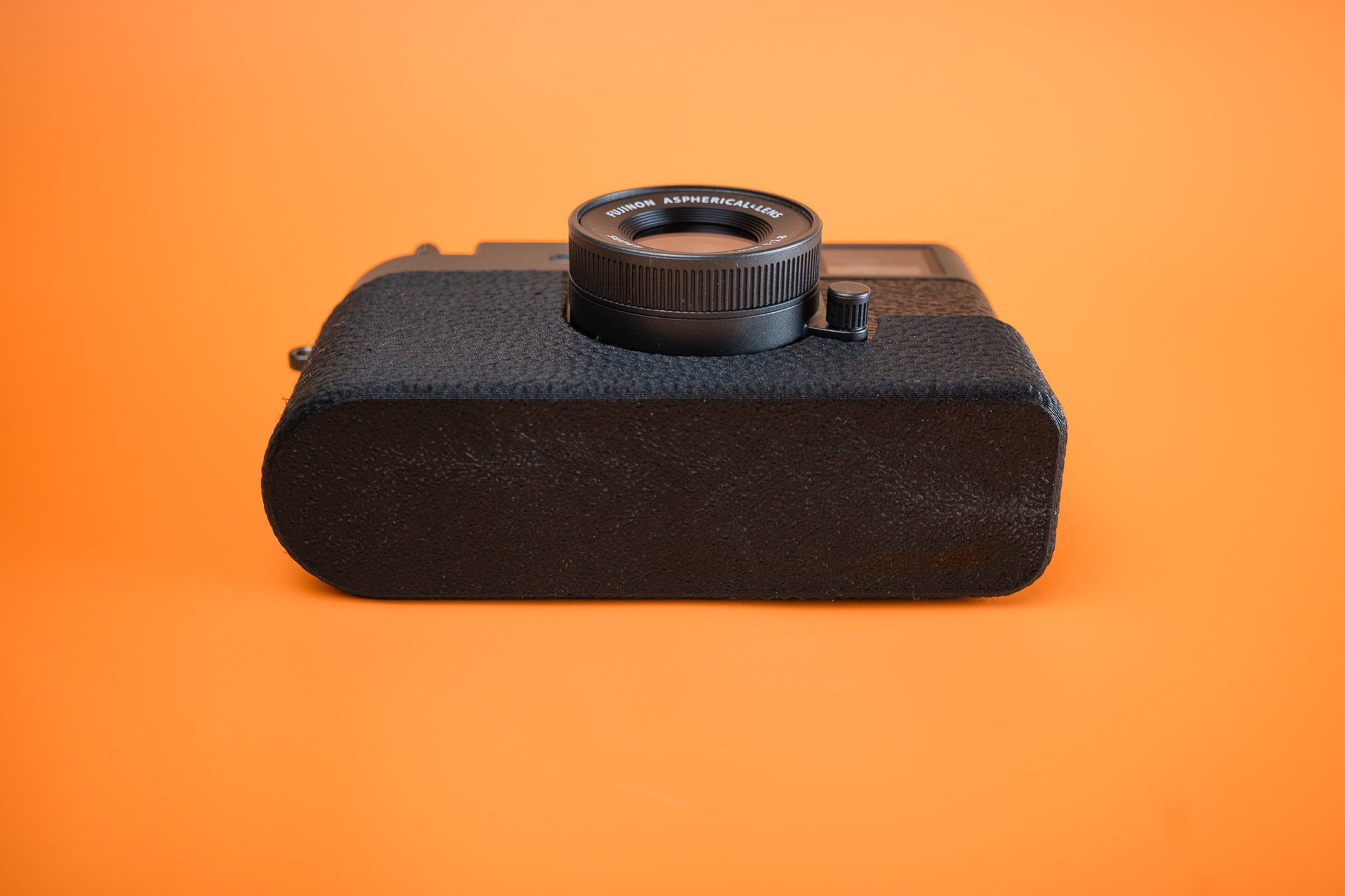 Fujifilm X half in Slim Skin Case with no grip, angled view showing base of the case