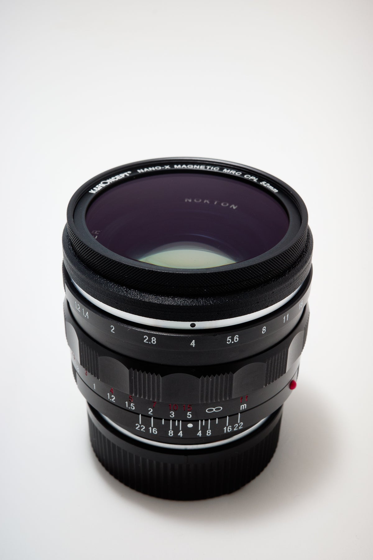 Leica M Mount Lens Stealth Rings - 49mm. Filter mounted on lens ring. White background