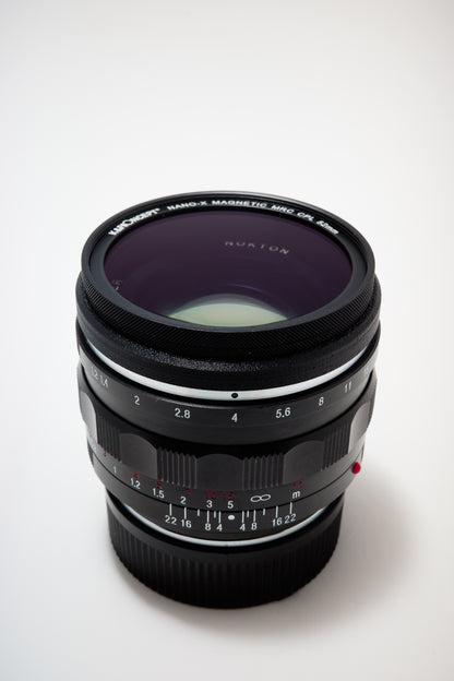 Leica M Mount Lens Stealth Rings - 49mm. Filter mounted on lens ring. White background
