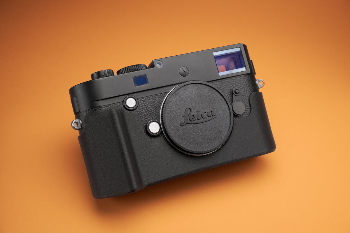Akara Labs Leica M10 Slim Skin case with grip on orange background.