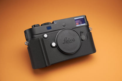 Akara Labs Leica M10 Slim Skin case with grip on orange background.