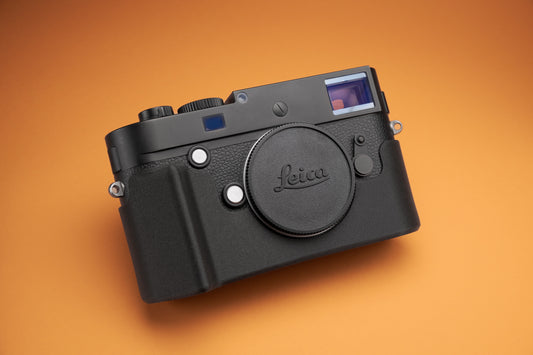 Akara Labs Leica M10 Slim Skin case with grip on orange background.
