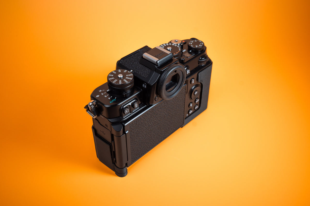 Nikon Zf TPU Slim Skin Case. Rear left high view of camera. Orange background.