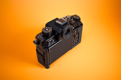 Nikon Zf TPU Slim Skin Case. Rear left high view of camera. Orange background.